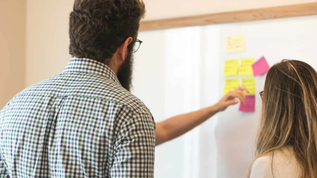 a man with a beard and a beard writing on a whiteboard AI-Powered Title Searches