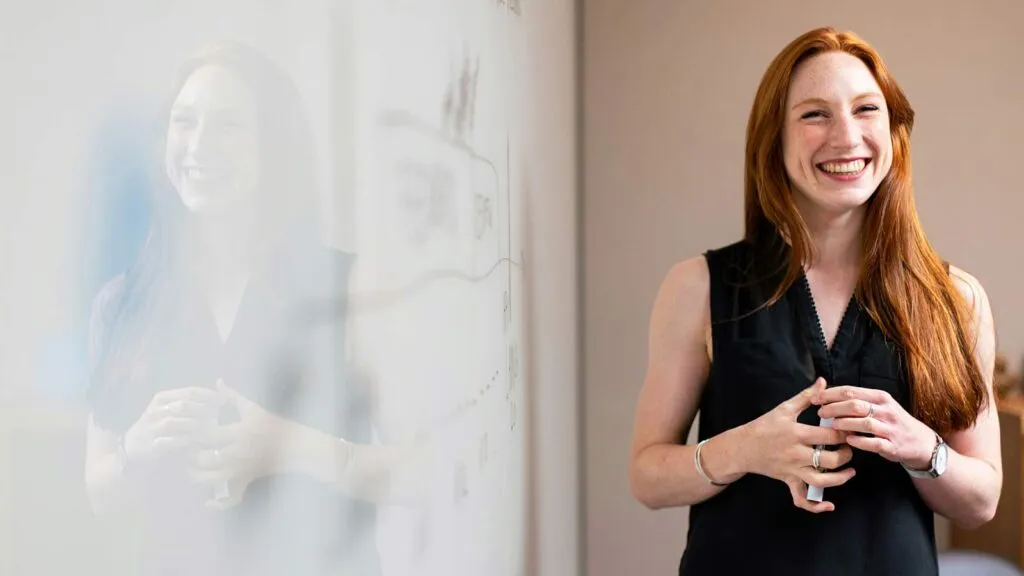 a woman standing in front of a whiteboard ECC algorithms