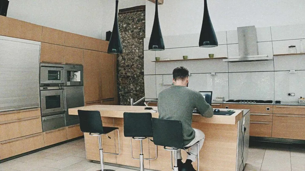 a man sitting at a table with a laptop mortgage lien lien release chain of title title search company title abstractor title search services mineral rights search title update