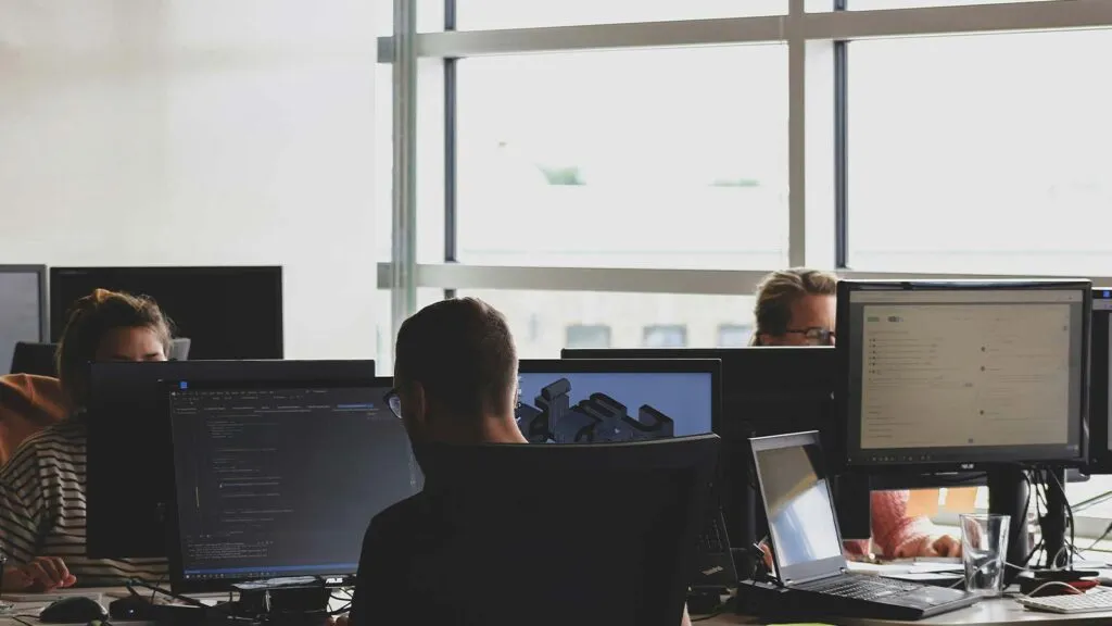 a group of people working on computers property deed